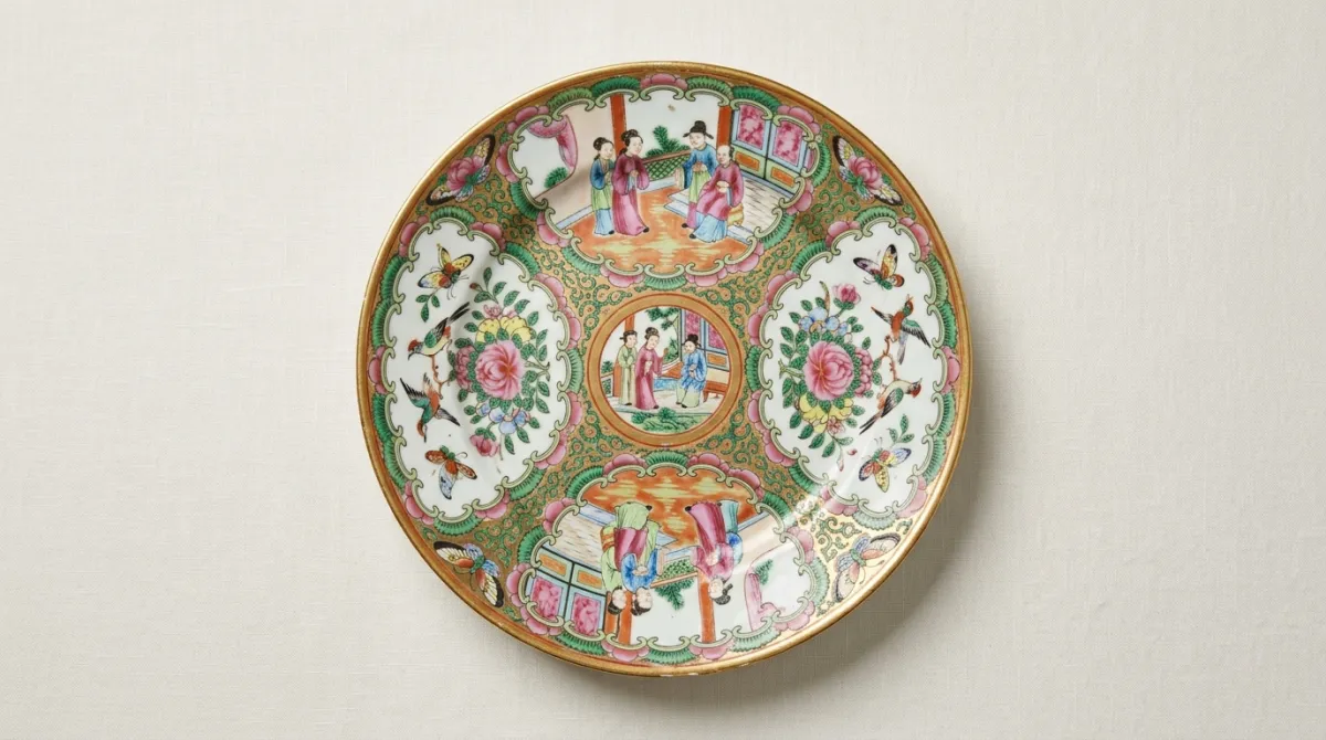An antique Rose Medallion dinner plate with famille-rose reserves and a gilt rim